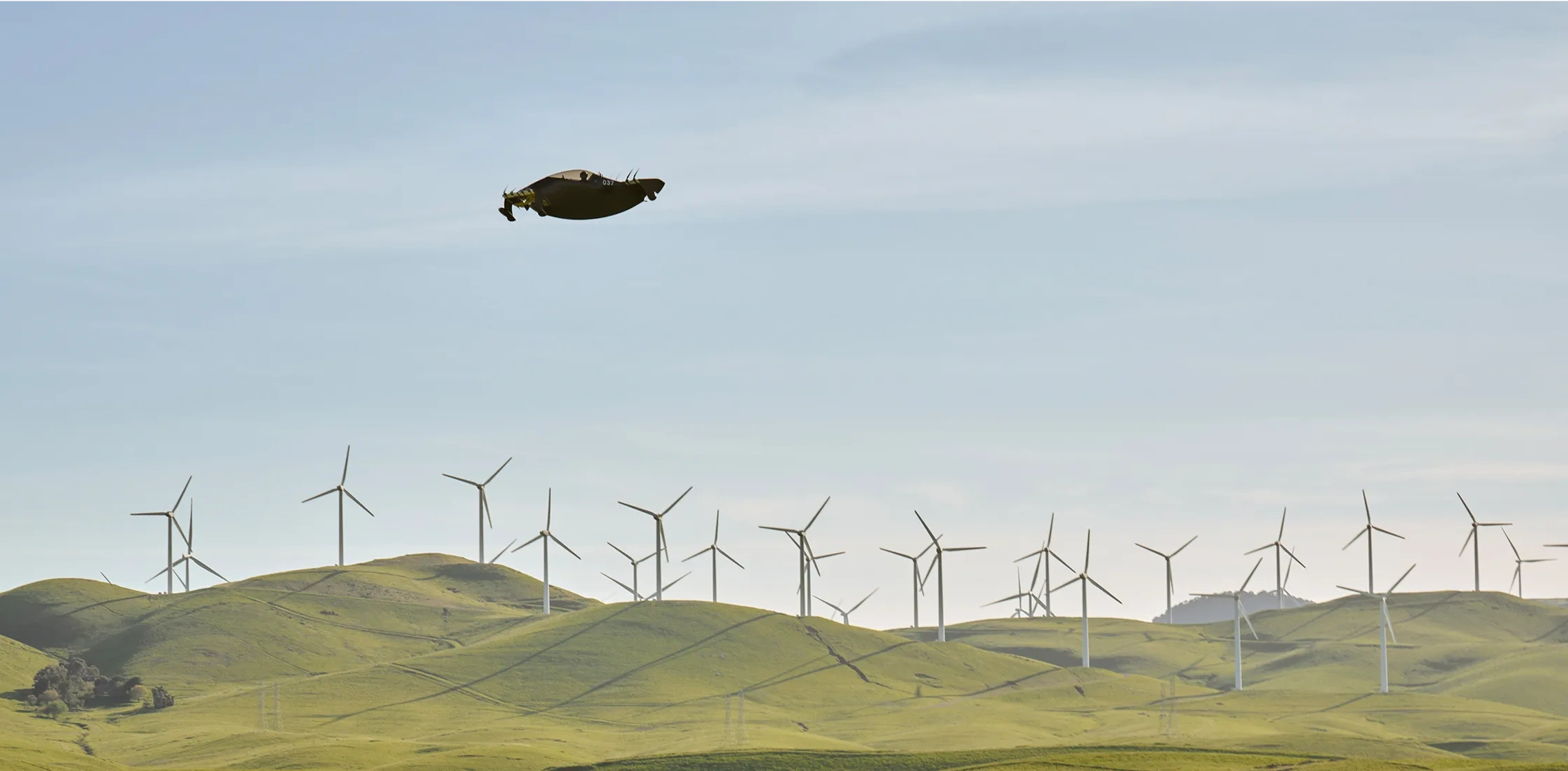A Pivotal aircraft over a windmill